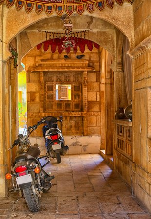 India, ordinary city yard with motorcycles. Stone archの写真素材
