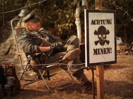 KIEV, UKRAINE - 01 OCT 2016: Old Car Land 2016 show. Poster in German - cautious mines and Nazi...