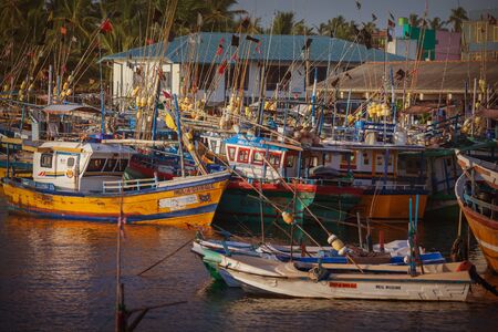 HIKKADUWA, SRI LANKA - CIRCA APR 2013: fishing port, old boats are on the waterのeditorial素材