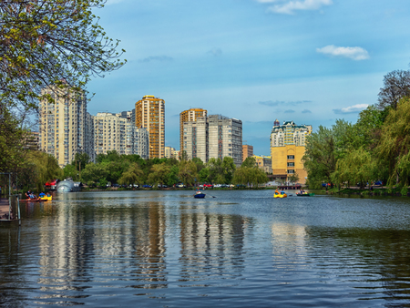 KIEV, UKRAINE - CIRCA MAY 2016: Holosiivskyi park, pond. Skyscrapers on backgroundのeditorial素材
