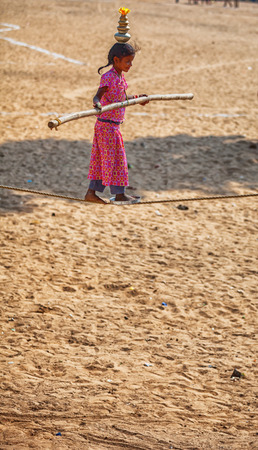 PUSHKAR, RAJASTHAN, INDIA - CIRCA NOV 2012: Traditional Fair in Pushkar. The girl tightrope Dancerのeditorial素材