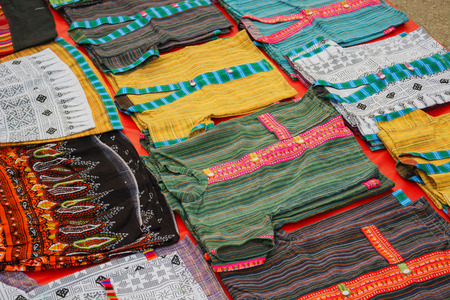 Laos - clothing market. Colored t-shirt on the floorの写真素材