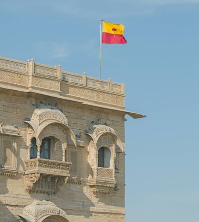Jaisalmer, Rajasthan, India. Jaisalmer flag over Royal Palace on sky backgroundの写真素材