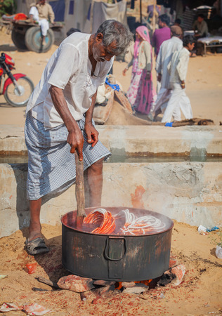 PUSHKAR, RAJASTHAN, INDIA - CIRCA NOV 2012: Local Artisan Dying Handmade Rope using Traditional Methods in Pushkar, Indiaのeditorial素材