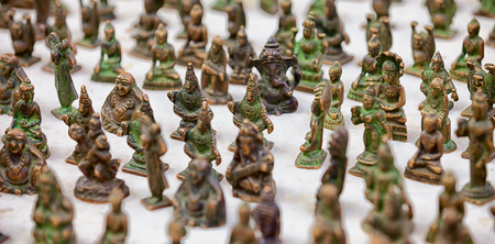 Jaisalmer, Rajasthan, India. Miniature bronze statuettes on the market counterの写真素材