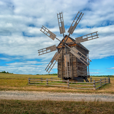 Ukraine, Kiev, Pirogovo. Ancient windmill on the field. blue sky backgroundの写真素材