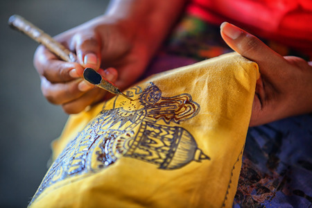 Sri Lanka, Anuradhapura. Artist sketching with an instrument to create a traditional work of art. Spouted tool - canting. Tjanting.の写真素材