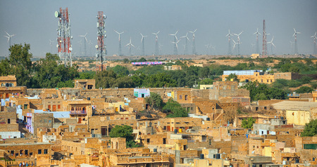 Jaisalmer, Rajasthan, India. Streets with cell towers and wind power generators in the backgroundの写真素材
