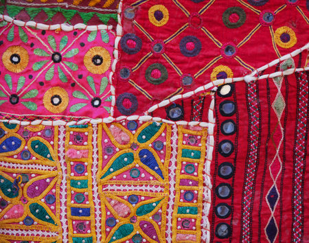 Section of an intricately detailed and colorful, Indian Wall Tapestry in closeup, for sale at a shop...