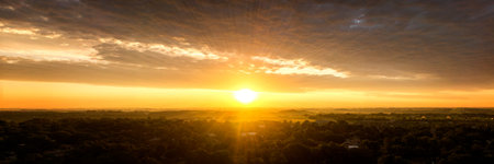 An Aerial view of the Sun rising through the clouds taken from 200 feet above ground with a UAV, ( Drone ) in South Dakota.の写真素材
