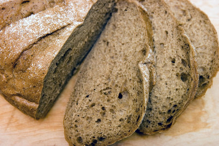 The rye loaf cut on a board close up