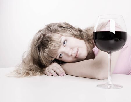 The young beautiful woman the blonde with red wine glassの写真素材