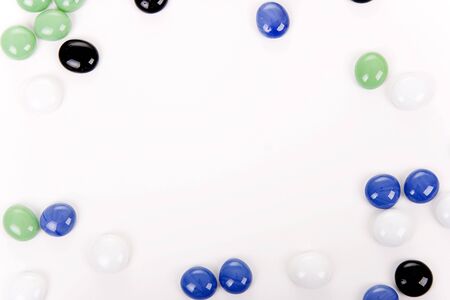 Colour round smooth stones on white tableの写真素材