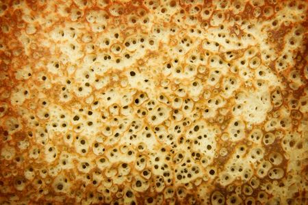 yellow porous texture of baked pancake closeの写真素材