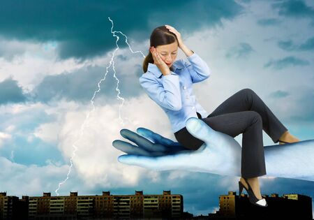 against a background of stormy skies girl is sitting on the blue arm of the giant
の写真素材