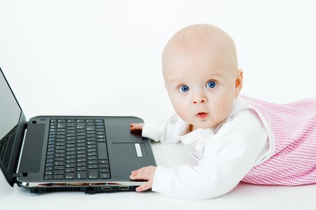 baby with laptop on a white background in studio
の写真素材