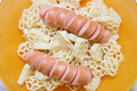 homemade sausage with pasta on the yellow plate
の写真素材