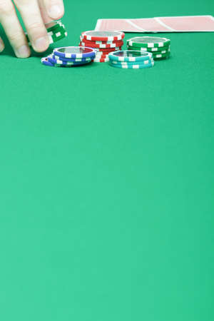 man's hand collects the chips with game tableの写真素材