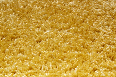 yellow carpet of artificial material close-up. The texture of the carpetの写真素材