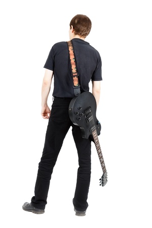 A young man with a black electric guitar isolated on white backgroundの写真素材