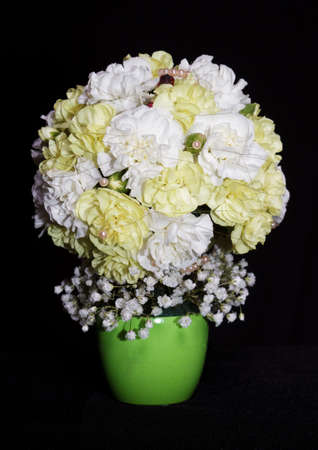 round festive bouquet of yellow carnations on a black backgroundの写真素材