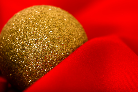 Christmas golden ball on a red cloth. macroの写真素材