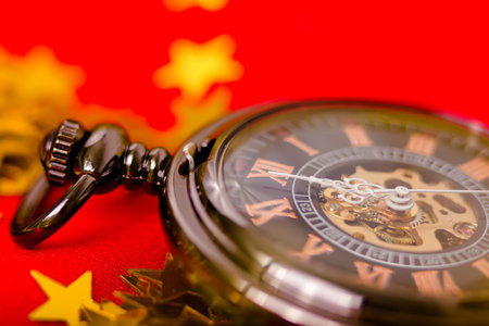 Christmas card. vintage pocket watch on a red background with golden decorations
