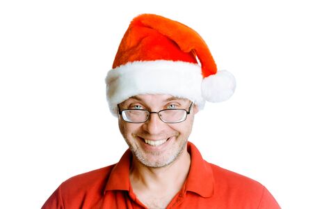 Smiling happy unshaven man on a white background with glasses and a hat Santaの写真素材
