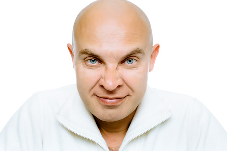 Bald evil grinning man. Isolated on white. Studioの写真素材