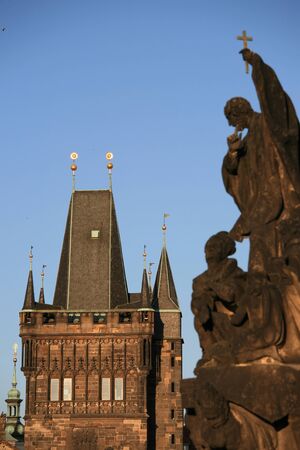 Statues on Charles bridge with New Town towers in Prague.の写真素材