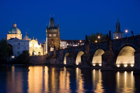 Charles bridge with New Town towers in Prague at night lighting.の写真素材