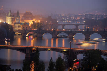 Twilight on Vltava river in Prague with bridges and boats.の写真素材