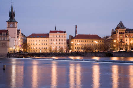 Smetana embankment in Prague with city houses at night illumination. Winter view.の写真素材