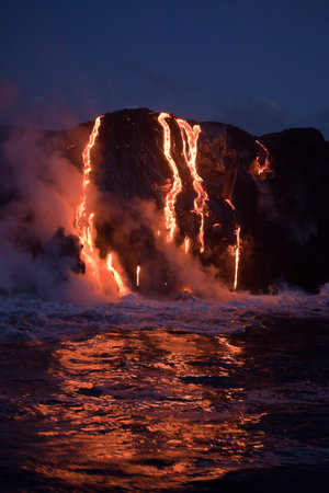 Hot lava stream is flowing into the ocean. Hawaii, Big Island.