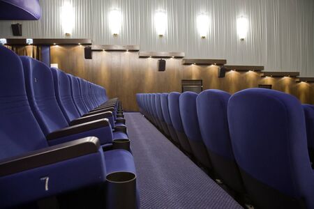 Interior of cinema auditorium with lines of chairs.の写真素材