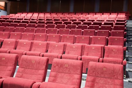 Interior of cinema auditorium with lines of chairs.の写真素材