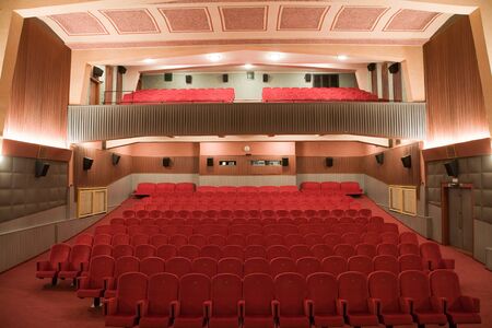 Empty retro cinema auditorium in cubism style with line of chairs.の写真素材