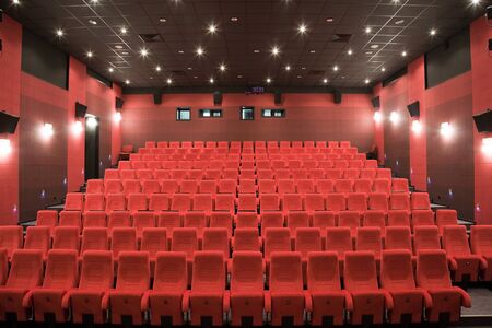 PR (property release) available. Empty cinema auditorium with line of red chairs.の写真素材