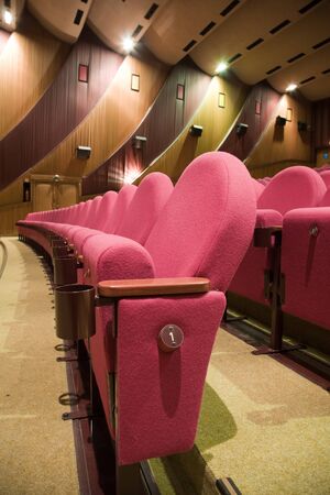 PR (property release) available. Empty cinema auditorium with line of chairs. Side view.の写真素材