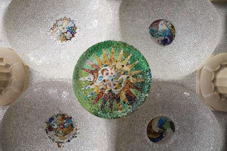 Closeup of chaotic Gaudi tile mosaic on ceiling in Parc Guel in Barcelona.の写真素材
