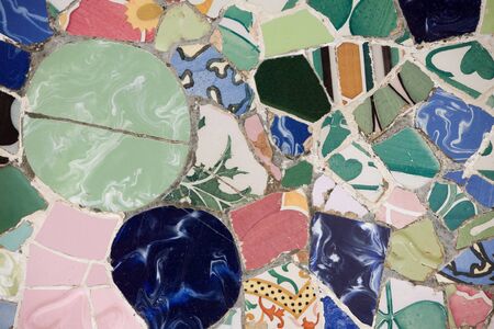 Closeup of chaotic Gaudi pink mosaic on seat in Parc Guel in Barcelona.の写真素材