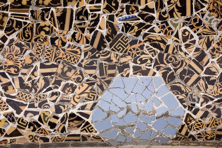 Closeup of chaotic Gaudi pink mosaic on seat in Parc Guel in Barcelona.の写真素材