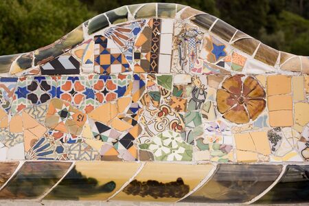Closeup of chaotic Gaudi pink mosaic on seat in Parc Guel in Barcelona.の写真素材