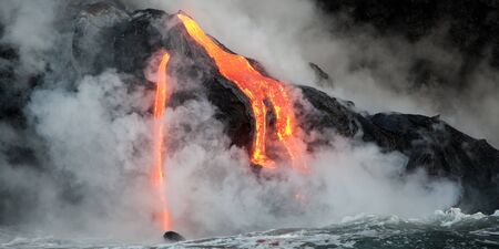 Hot lava stream is flowing into the ocean. Hawaii, Big Island.の写真素材