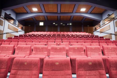 Interior of cinema auditorium with lines of chairs.の写真素材
