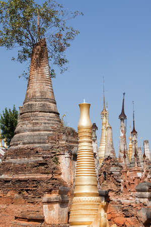 Shwe Inn Thein Paya, Indein, Burma. Weather-beaten buddhistic zedi constructed in 17th and 18th century damaged by earthquake in 1975, partitialy back reconstructed.の写真素材