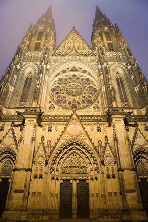 Gothic towers of the famous cathedral of St. Vitus in Prague are touching the fog.の写真素材