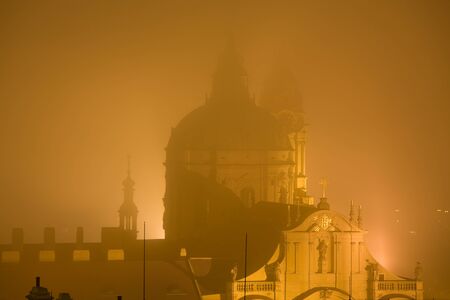 Baroque style St. Nicholas church in Prague surrounded by fog.の写真素材