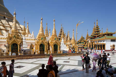 People are walking in the biggest Buddhist temple Shwedagon pagoda, Rangoon, Burma.のeditorial素材