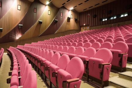 PR (property release) available. Empty cinema auditorium with line of chairs. Side view.の写真素材